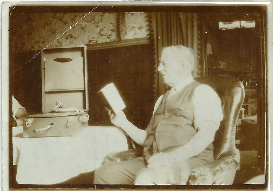 Ernest Armitage in his kitchen reading a book in his kitchen